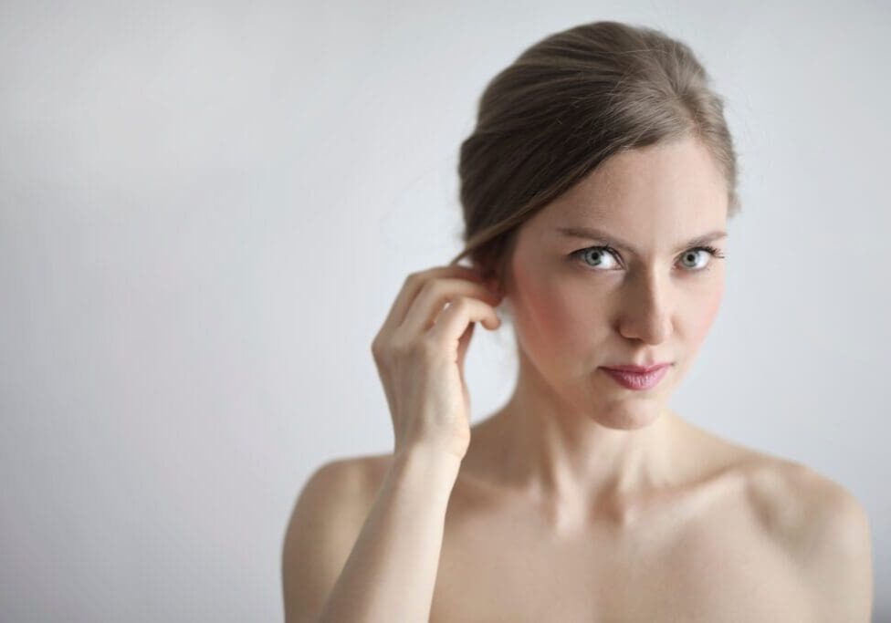 Woman with light brown hair looking at camera.